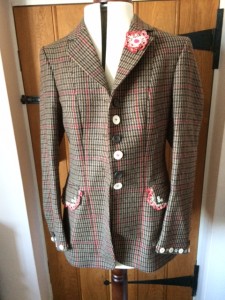 Attractive tweed jacket with red check. Decorated with buttons and pretty vintage lace