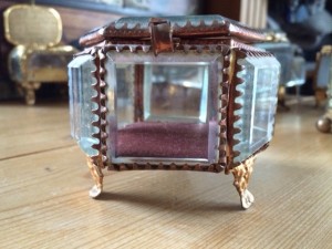 Pretty glass sides and four gilded feet.